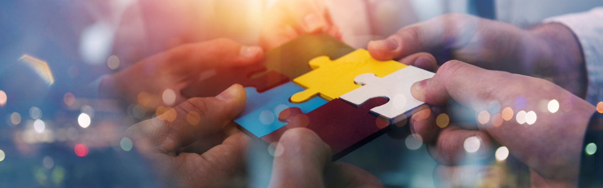 people holding puzzle pieces